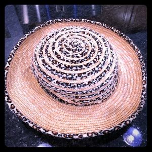 Straw hat with leopard material trim around it